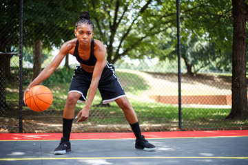 Portrait of woman playing basketball