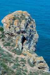 A huge rock shaped head over the sea.  Black Sea, Bulgaria. The shore at Cape Kaliakra is a cliff type, the sheer cliffs descend 70 meters down to the sea.
