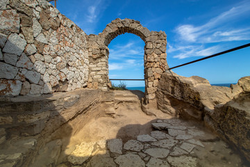 Ancient fortress on Cape Kaliakra above the sea against a background of azure sky. Northern Black Sea Coast, Bulgaria. The earliest settlement of the cape dates from the IV century BC. 