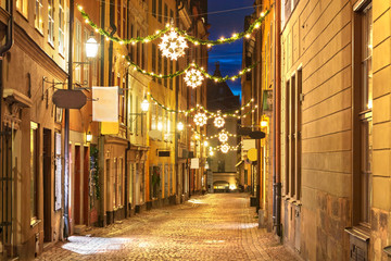 Street in Old Town (Gamla Stan) decorated for Christmas time at night, Stockholm, Sweden