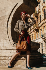 Outdoor full-length fashion portrait of elegant, luxury woman wearing trendy leather midi skirt,...