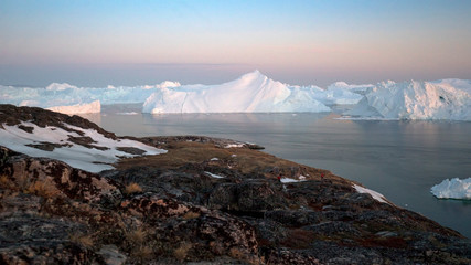 icebergs are melting in arctic ocean in greenland