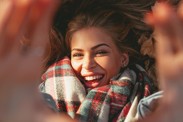 Young happy woman doing selfie in a park