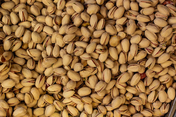 pistachios fried salted nuts textured  background food picture in supermarket counter 