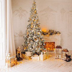 classical interior of a white room with a decorated fireplace, luxury Christmas tree, garlands, candles, lanterns, gifts. day. pink sofa pastel colors
