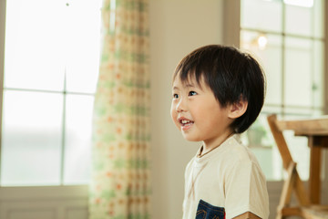 Side view of smiling boy at home