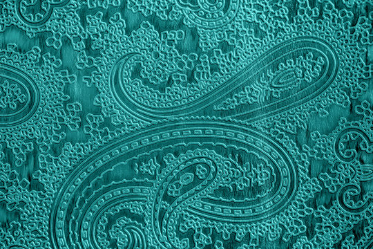 Texture of genuine leather close-up, green mint color with embossed floral trend pattern, for wallpaper or banner design