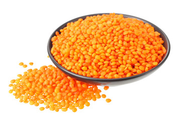 Pile lentil in black bowl isolated on white background