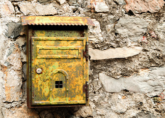 Old rusty mailbox on brick wall
