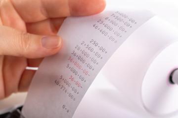 Fototapeta premium Accounting Female Hand Checking Expenses Closeup Focus