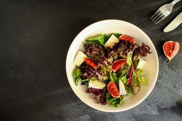 healthy salad from mix leaves, figs, cheese (tasty snack, vitamins, healthy food) menu concept. food background. copy space. Top view