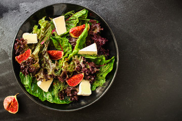 healthy salad from mix leaves, figs, cheese (tasty snack, vitamins, healthy food) menu concept. food background. copy space. Top view