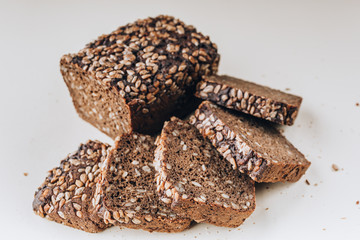 Rye yeast-free bread with sunflower seeds on a light background.