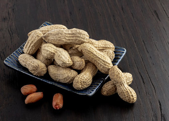 a group of shelled peanuts on wood background
