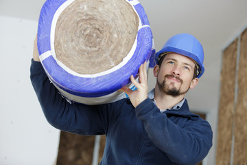 man carrying thermal insulation roll