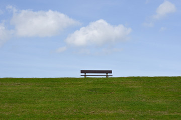 Bench on the grass hill