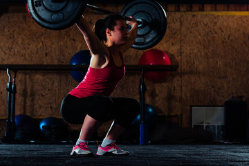 Fototapeta na wymiar Caucasian female exercising in the gym