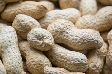 Peanut in a shell texture. Food background of organic delicious peanuts