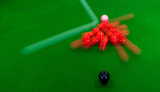 Snooker Break with Long Exposure to show white hitting red triangle and the balls movings on full size billiards table