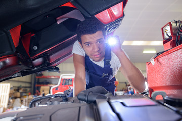 a mechanic checking an engine