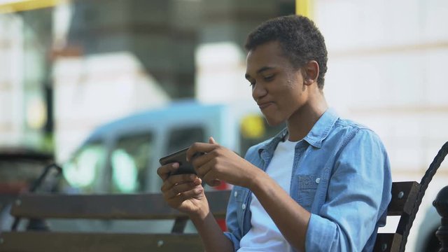 Emotional teenager freaking out after losing online smartphone game, addiction