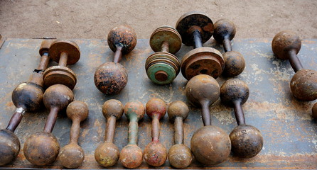 Old dumbbells at a flea market. Swap meet. Dirt mall. Junkfest. Vintage market.