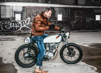Plakat man on his vintage retro motorcycle 