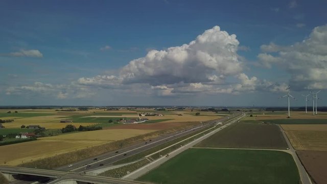 Aerial view of Highway A8 and wind turbines in corn fields on the swabian alp between Ulm and Merklingen with construction works of the Stuttgart21 railway project