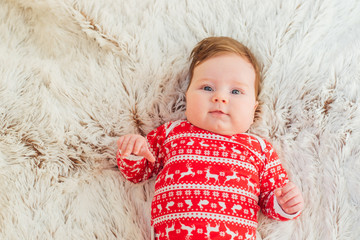 Portrait of a cute little baby wearing christmas clothes 