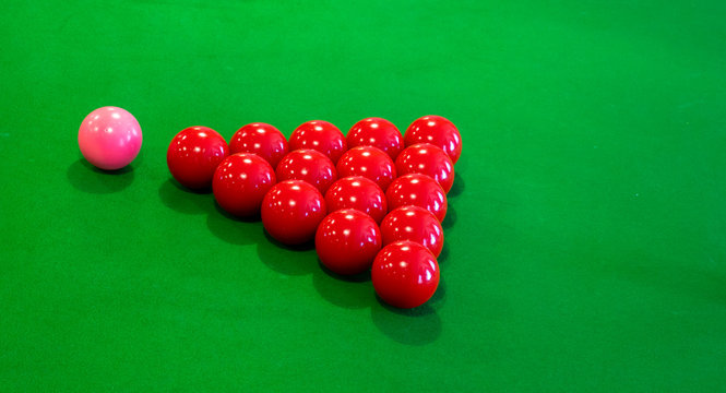 snooker table and red pink and black balls from breakoff time lapse long exposure to show movement on table