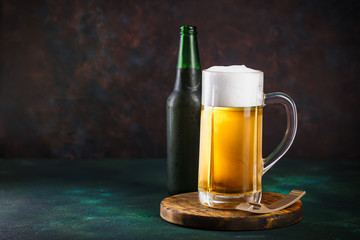 Mug of beer on dark background