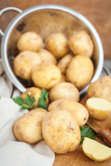 Raw potato. Fresh new potatoes on wooden background