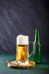 Mug of beer on dark background