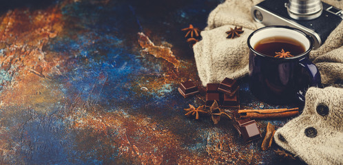 Hot winter tea with cinnamon stick and chocolate