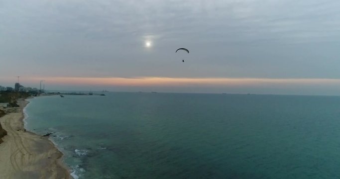 Parachute flying at sunset near the coast of Ashkelon Israel 
