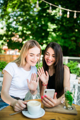 two beautiful young women talking on video call on phone