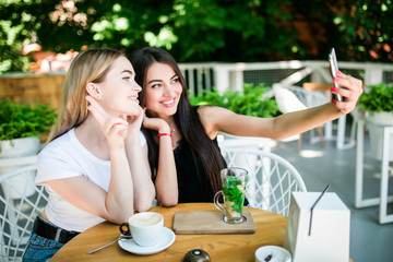 two beautiful young women talking on video call on phone