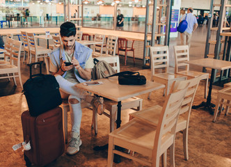 Man sitting at the airport lounge, waiting for the flight