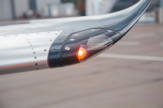 navigation light on the wing of jet airplane in airport
