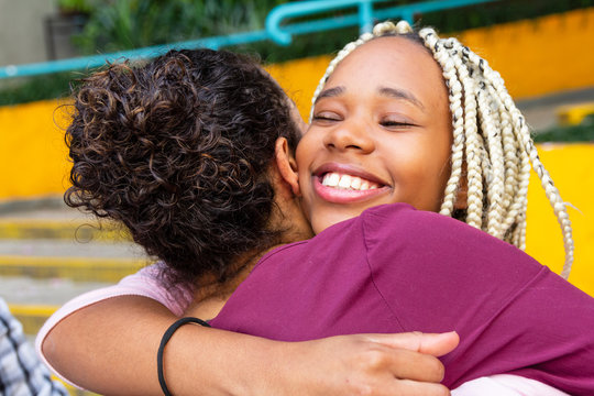 Happy person gives his friend a tight hug. Celebrations, reunions, meetings, friendship. Affection and union.