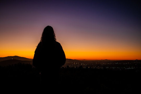 Silhouette of a woman looking at city lights, Stellenbosch, Western Script, South Africa