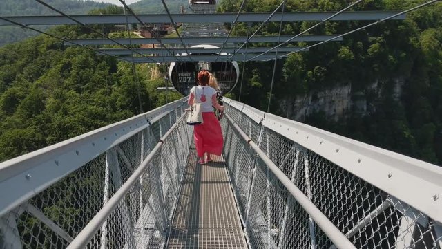 Sochi, Russia - may 2019. People going at skybridge in Skypark Sochi. Follow shot