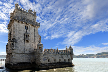 Fototapeta na wymiar Scenic Belem Tower and wooden bridge miroring with low tides on Tagus River. Torre de Belem is Unesco Heritage and icon of Lisbon and the most visited attraction in Lisbon, Belem District, Portugal