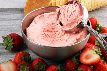 Strawberry ice cream scoop on a rustic white background