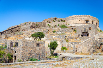 Fototapeta na wymiar The ruins of old buildings in Spinalonga island of lepers in Crete, Greece