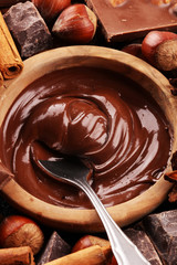 Chocolate bar pieces and melting swirl cocoa. Sweet food photo concept. The chunks of broken chocolate on table