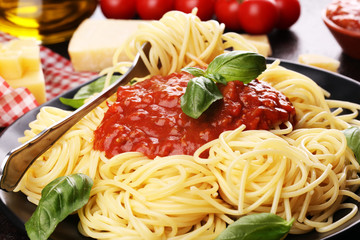 Plate of delicious spaghetti Bolognaise or Bolognese with savory minced beef and tomato sauce garnished with parmesan