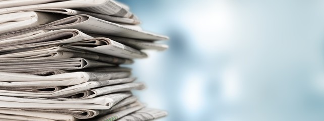 Pile of newspapers on white background