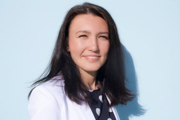 portrait of a young woman with white smile in studio and  beautiful skin