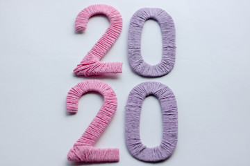 Happy New Year 2020. Creative text Happy New Year 2020 written sparkling sparklers isolated on black background for design. Beautiful